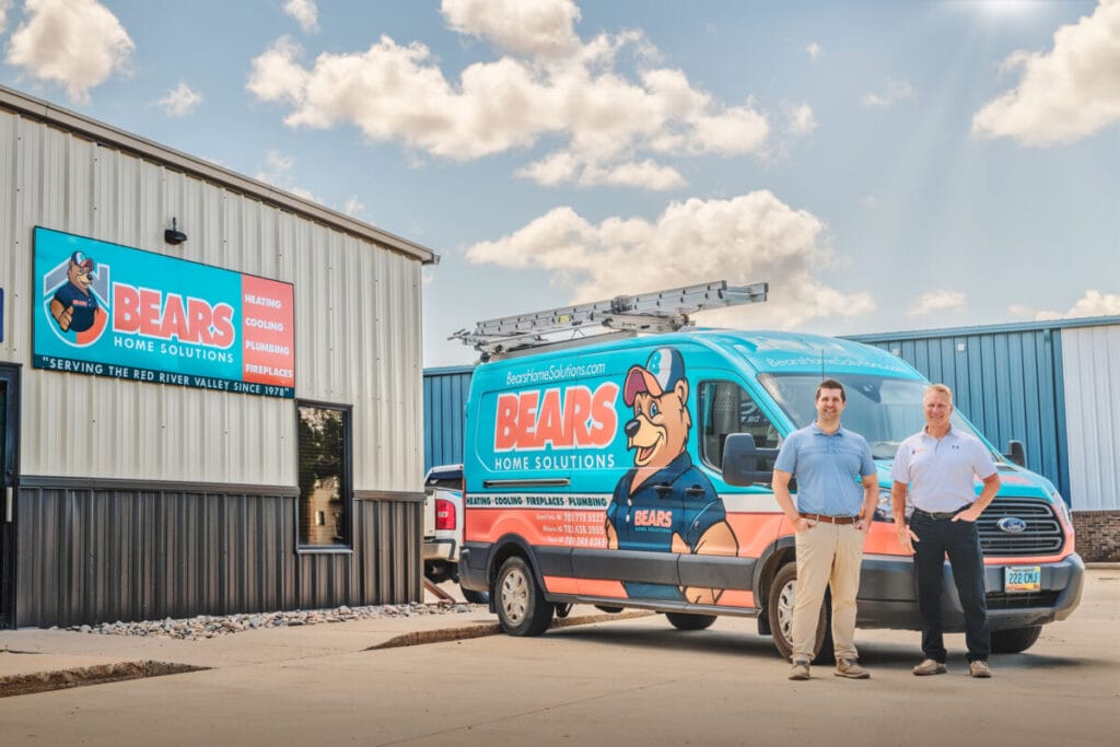 two_men_in_front_of_bears_van