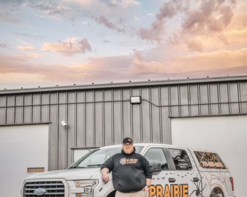 man_in_front_of_the_praire_pest_control_truck