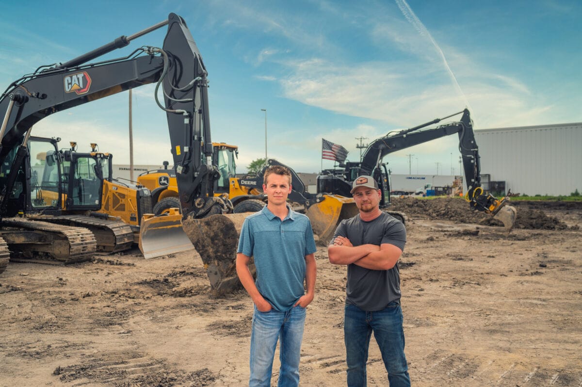 two_men_in_front_of_excavation_equippment